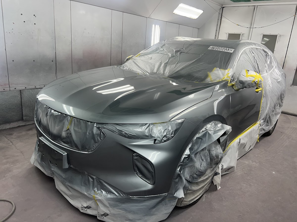 Luxury SUV with a fresh color-matched finish in the paint booth