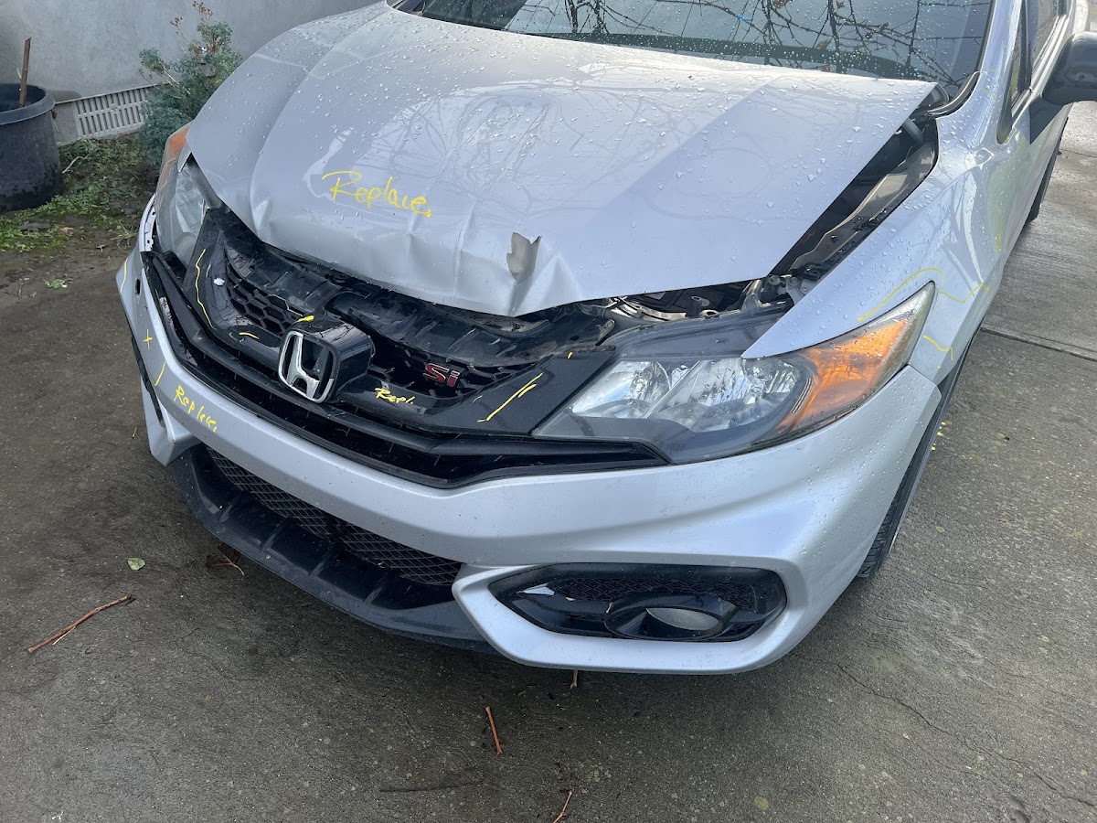 Honda Civic with front-end collision damage, marked for repair